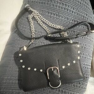 black leather Rebecca Minkoff crossbody with silver studs, buckle and chain.